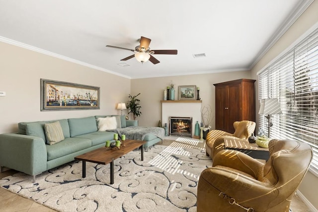 tiled living room with ceiling fan and ornamental molding