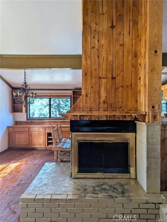 details with a fireplace and a chandelier