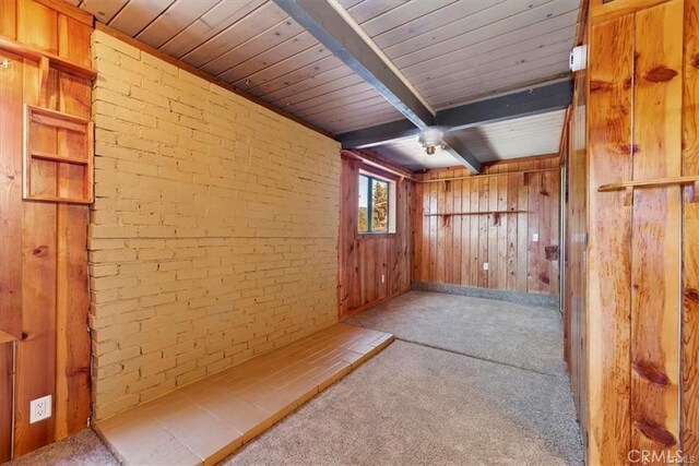 bonus room with wood walls, brick wall, beamed ceiling, carpet floors, and wood ceiling