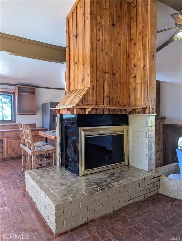 details with ceiling fan and a brick fireplace