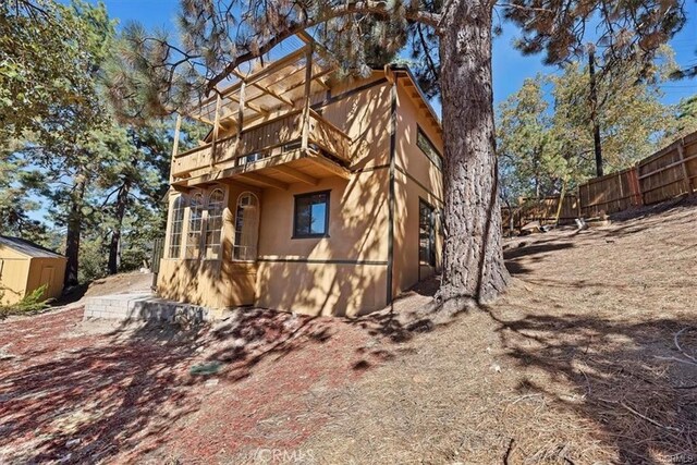 view of side of home with a storage unit