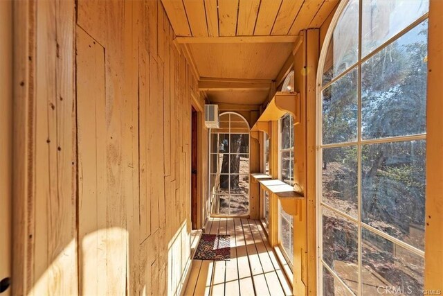 sunroom / solarium featuring wooden ceiling