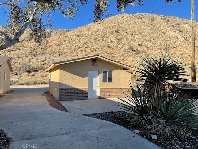 view of front of home with a mountain view and a patio