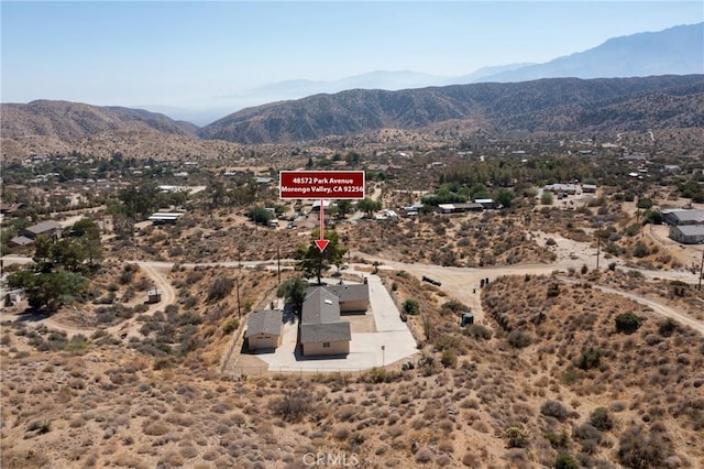 birds eye view of property with a mountain view