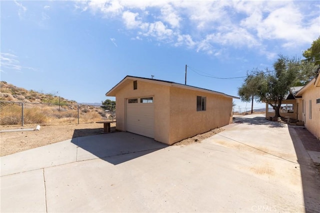 view of side of home with a garage and an outdoor structure