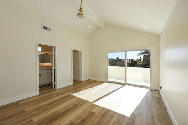 unfurnished bedroom featuring ensuite bathroom, ceiling fan, access to exterior, beam ceiling, and light hardwood / wood-style flooring