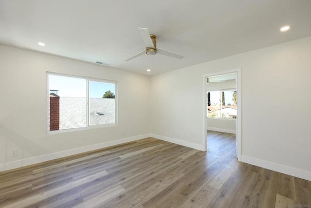 spare room with light hardwood / wood-style floors and ceiling fan