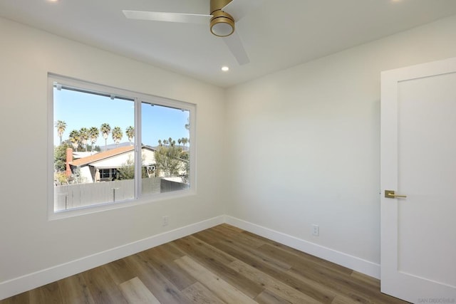 empty room featuring ceiling fan and hardwood / wood-style flooring