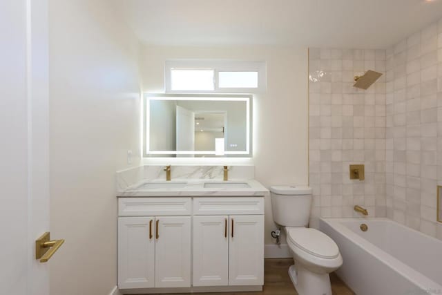 full bathroom featuring toilet, vanity, and tiled shower / bath