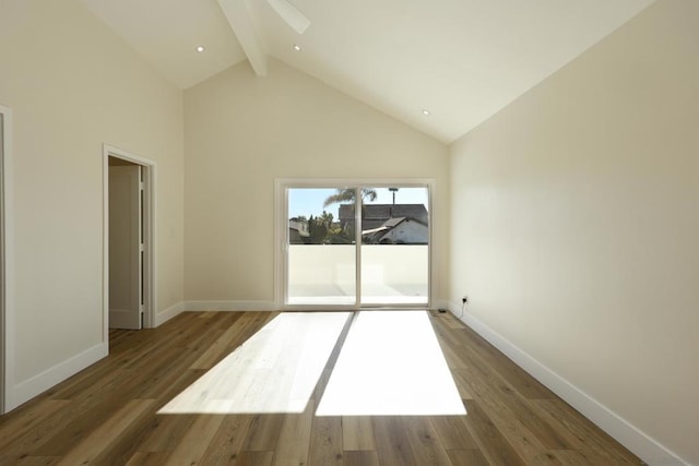 unfurnished room with dark hardwood / wood-style flooring, beam ceiling, and high vaulted ceiling