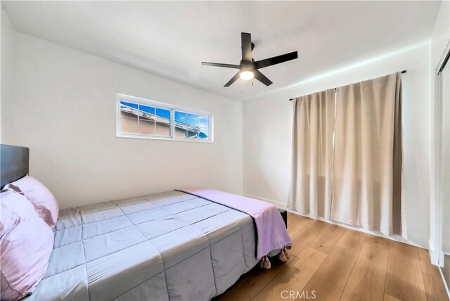 bedroom with light wood-type flooring and ceiling fan