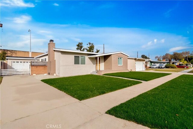 ranch-style home featuring a front lawn and a garage