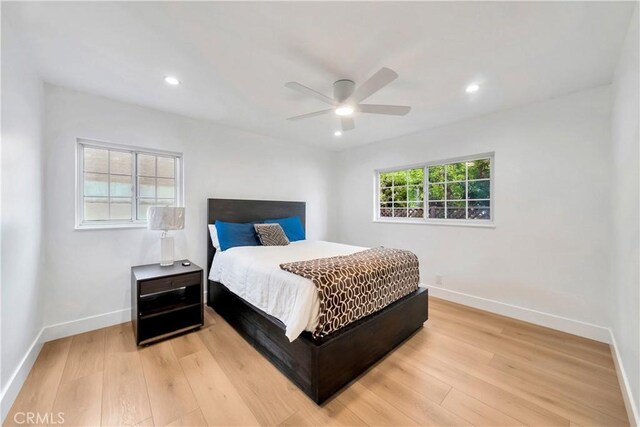 bedroom with ceiling fan and light hardwood / wood-style flooring