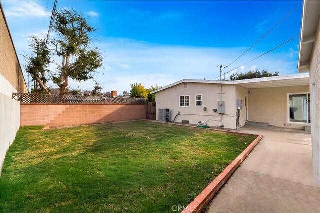 view of yard with a patio area and central air condition unit