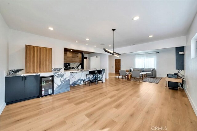 living room with wine cooler and light hardwood / wood-style floors