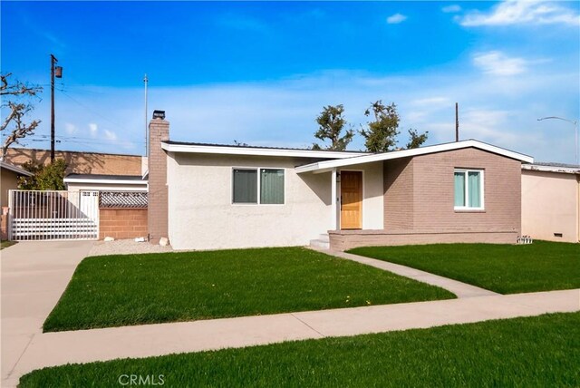 view of front of home featuring a front lawn and a deck