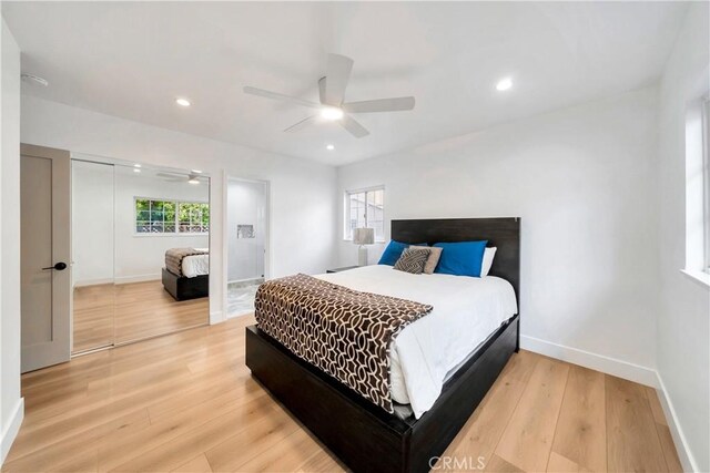 bedroom featuring ceiling fan, a closet, and hardwood / wood-style flooring