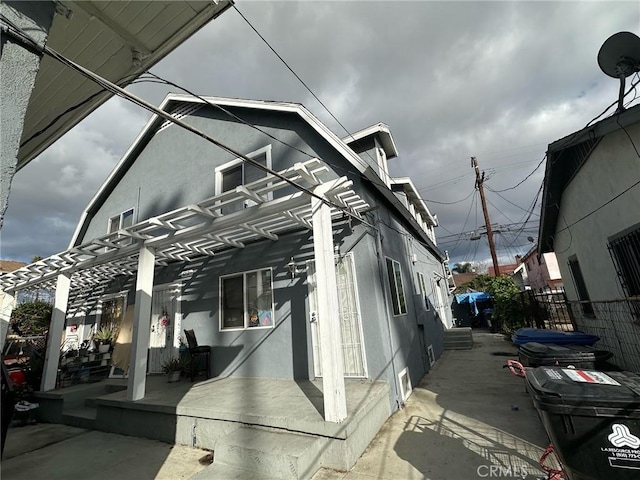 4210 Woodlawn Ave, Los Angeles, CA 90011 - view of property exterior featuring stucco siding and a pergola