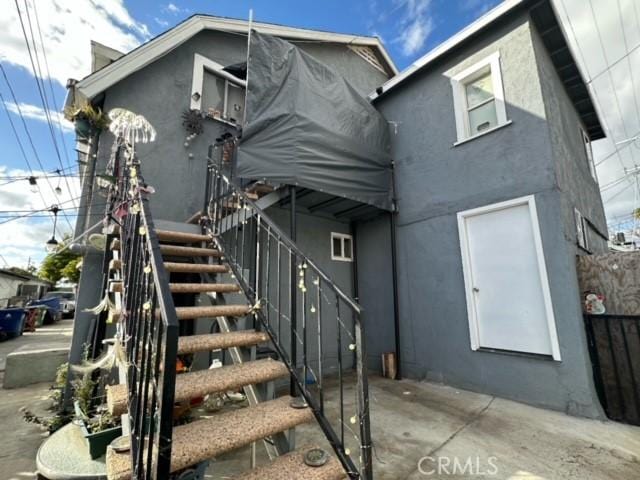 4210 Woodlawn Ave, Los Angeles, CA 90011 - view of front of house with stucco siding and stairs