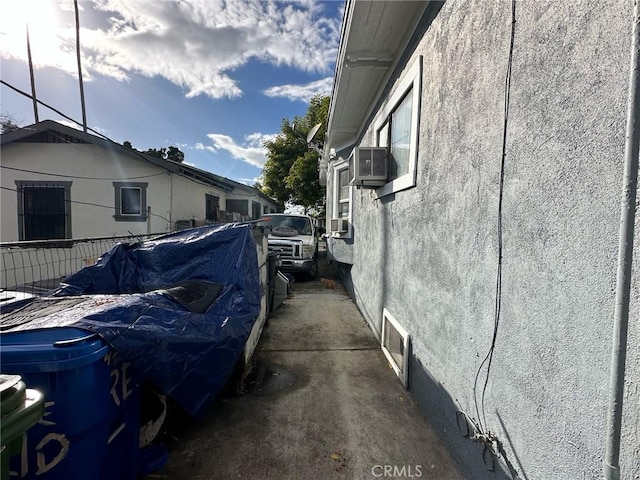 4210 Woodlawn Ave, Los Angeles, CA 90011 - view of side of home with stucco siding and cooling unit