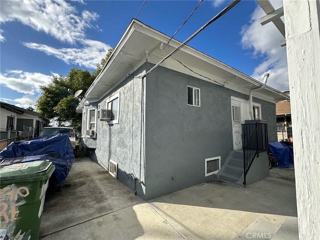 4210 Woodlawn Ave, Los Angeles, CA 90011 - view of home's exterior with stucco siding, a patio, and cooling unit