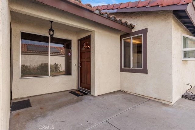 entrance to property with a patio