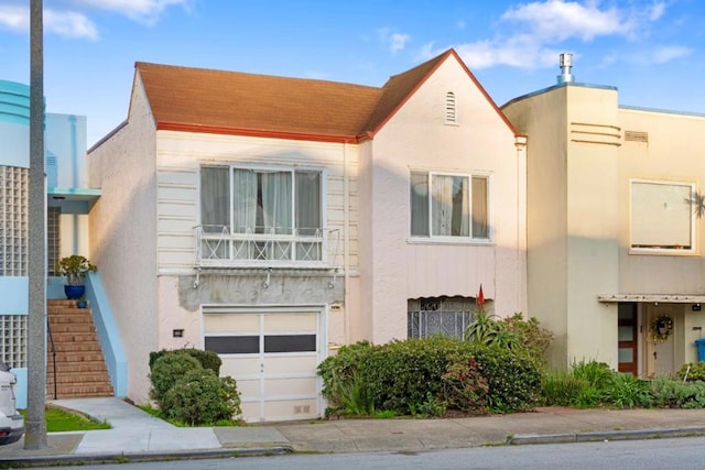 view of front of house with a balcony and a garage