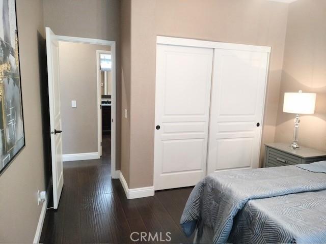 bedroom with a closet and dark hardwood / wood-style flooring