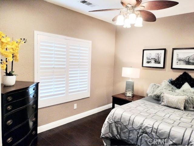 bedroom with ceiling fan and dark hardwood / wood-style floors