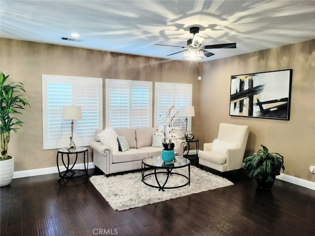 living room featuring ceiling fan and dark hardwood / wood-style flooring