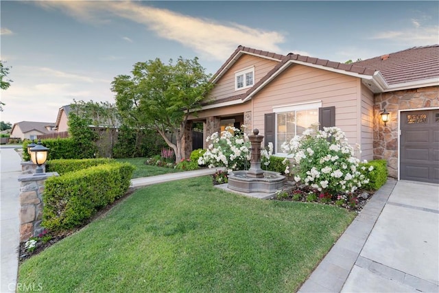 view of front of property featuring a lawn and a garage