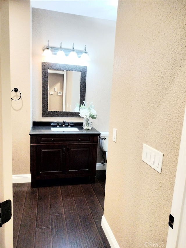 bathroom featuring toilet and vanity