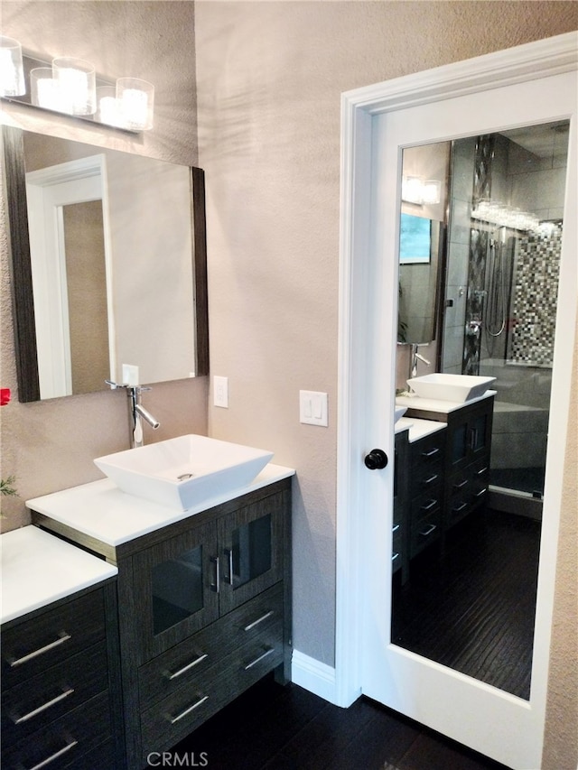 bathroom featuring walk in shower and vanity