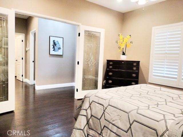 bedroom with dark wood-type flooring