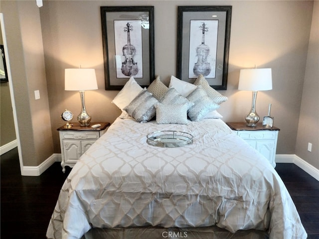 bedroom with dark hardwood / wood-style floors