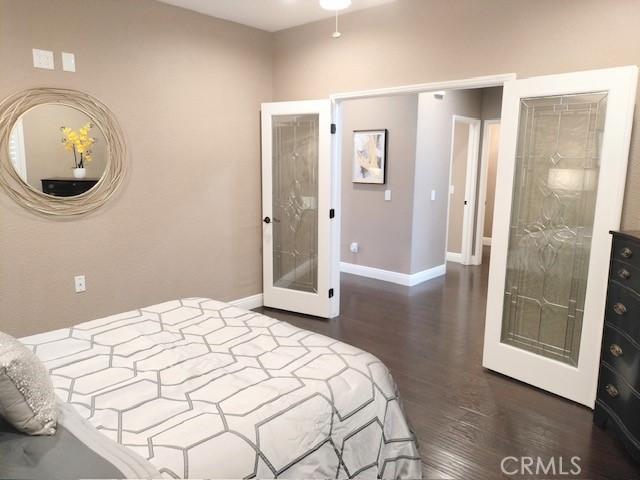 bedroom featuring french doors and dark hardwood / wood-style flooring