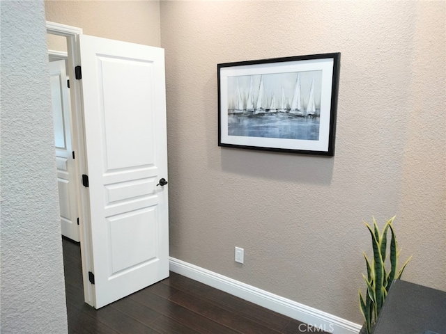 corridor featuring dark wood-type flooring