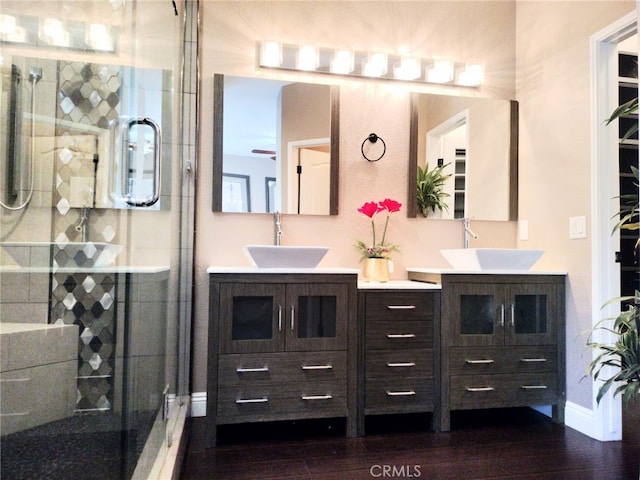 bathroom featuring hardwood / wood-style floors, vanity, and an enclosed shower