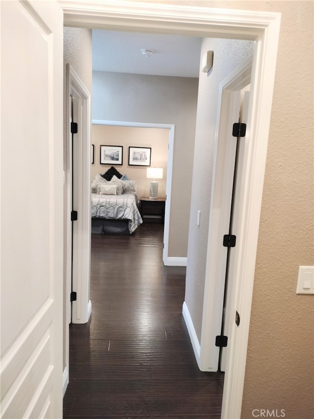 corridor featuring dark wood-type flooring