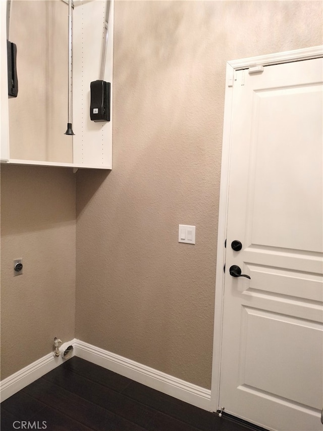 clothes washing area featuring hardwood / wood-style flooring and hookup for an electric dryer