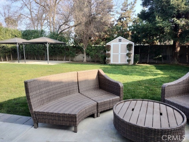 view of patio with a gazebo and a storage shed