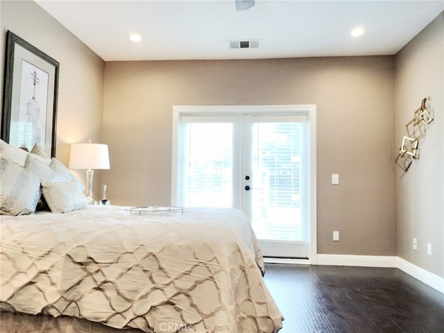 bedroom with dark hardwood / wood-style floors and access to outside