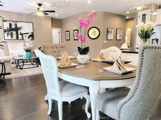 dining space featuring ceiling fan and dark hardwood / wood-style floors