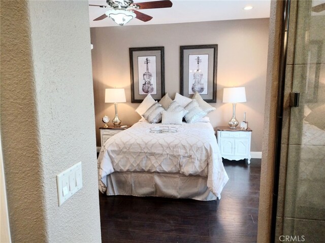 bedroom featuring ceiling fan and dark hardwood / wood-style flooring