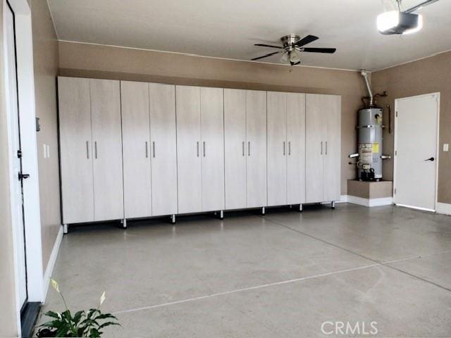 garage with a garage door opener, strapped water heater, and ceiling fan