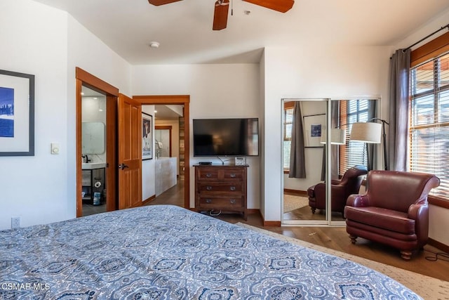 bedroom featuring dark hardwood / wood-style flooring, ceiling fan, and a closet