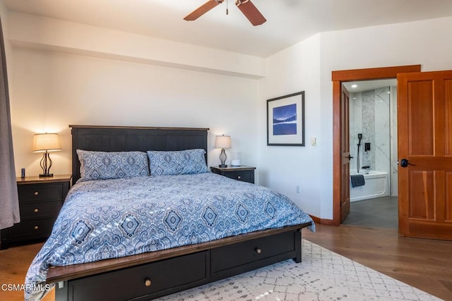 bedroom with ensuite bathroom, ceiling fan, and hardwood / wood-style flooring