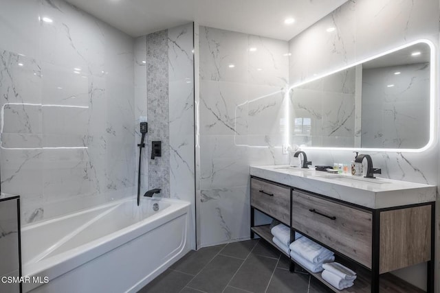 bathroom featuring tile patterned flooring, vanity, shower / tub combination, and tile walls