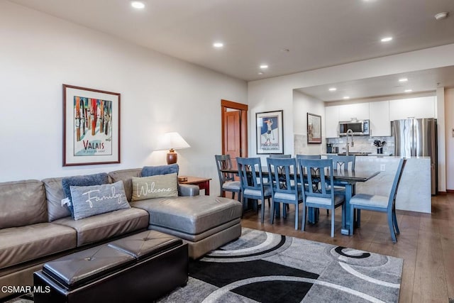 living room featuring dark hardwood / wood-style floors and sink