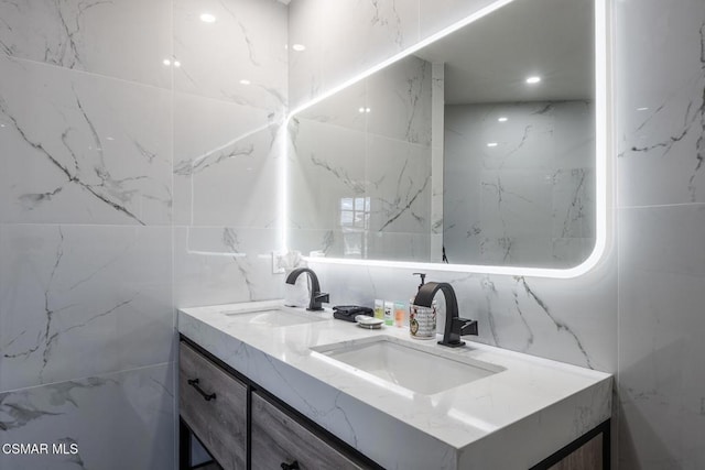 bathroom with vanity and tile walls